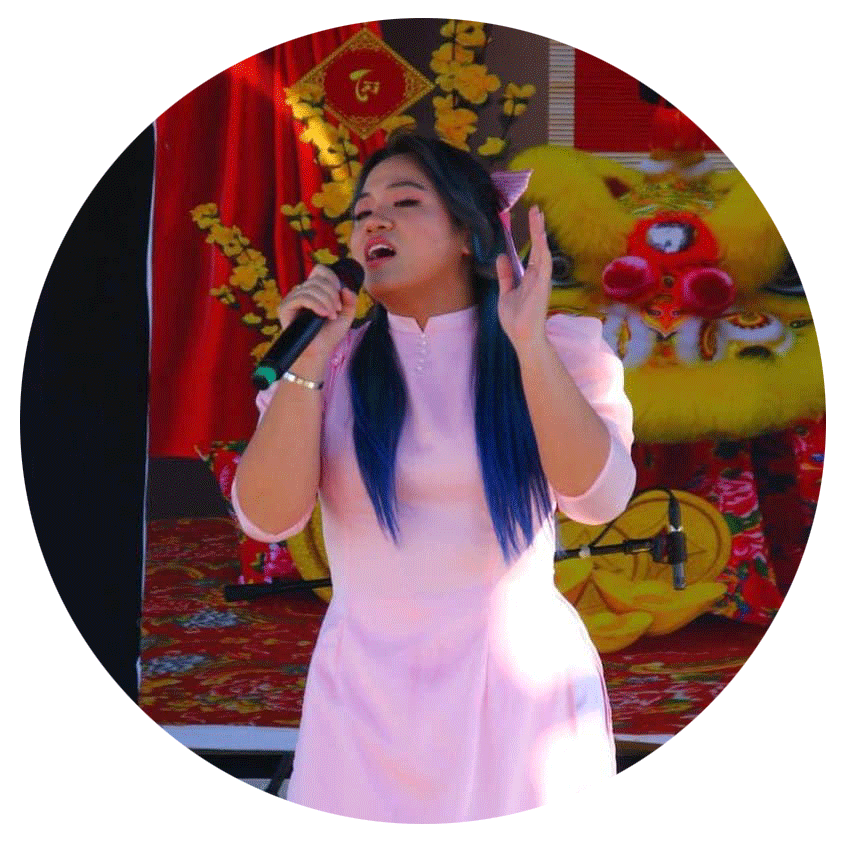 Photo of Emily Nguyen singing for Lunar New Years in 2023 at the Vietnamese Martyrs Catholic Church.